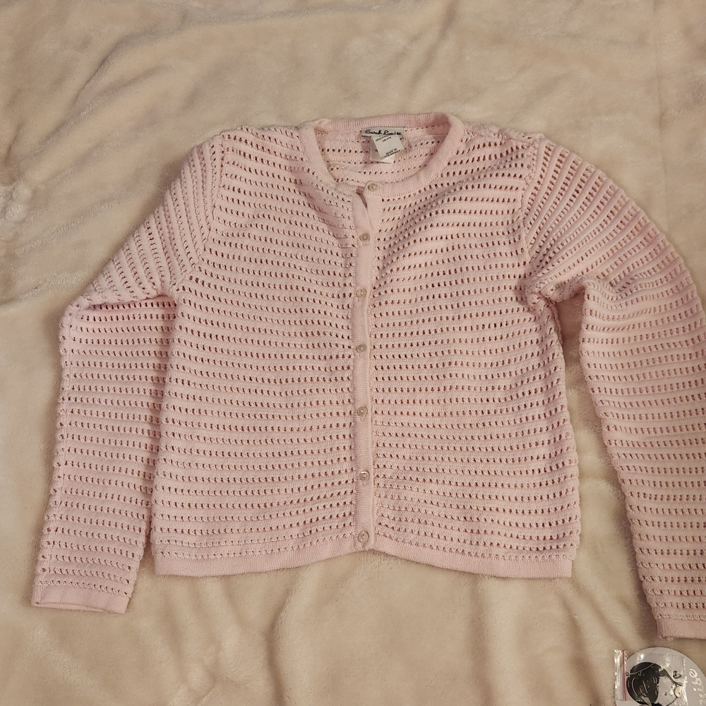 Pretty pink pointelle cardigan for girls from , Sarah Louise. Knitt